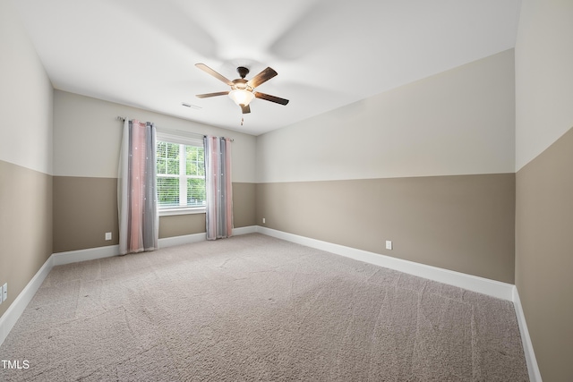 empty room with baseboards, a ceiling fan, visible vents, and carpet
