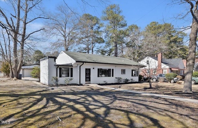 view of front of property featuring an outbuilding and a garage