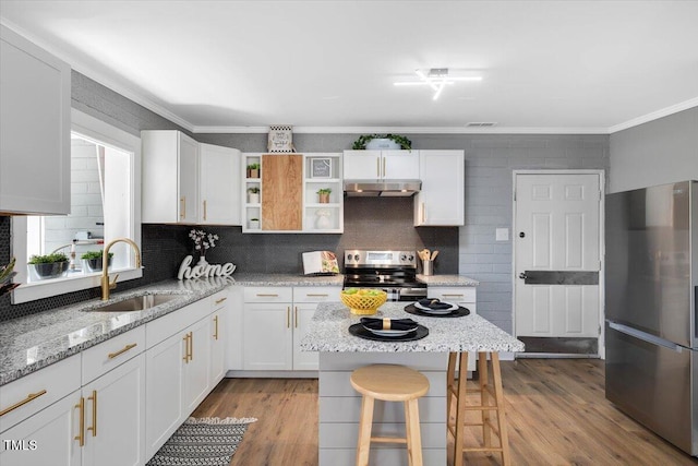 kitchen featuring sink, stainless steel appliances, white cabinets, and light stone countertops