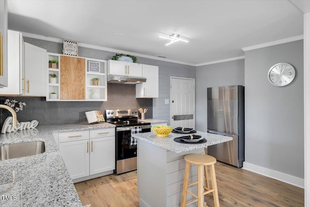 kitchen with white cabinetry, sink, light stone countertops, and appliances with stainless steel finishes