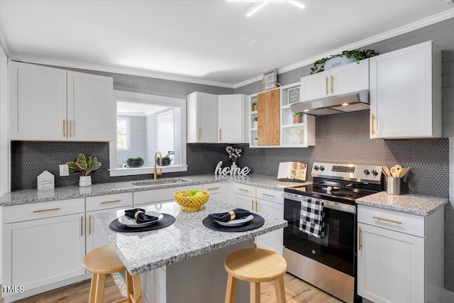 kitchen featuring sink, white cabinets, a kitchen bar, exhaust hood, and stainless steel electric range