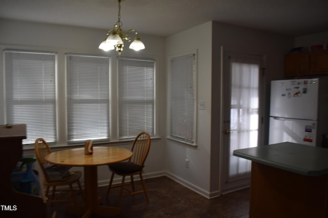 dining space with an inviting chandelier