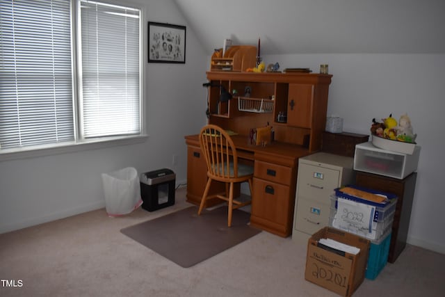 home office featuring lofted ceiling and light carpet