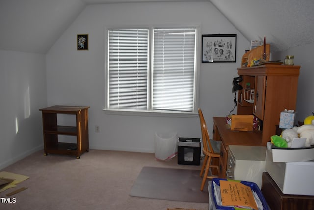 carpeted home office featuring vaulted ceiling