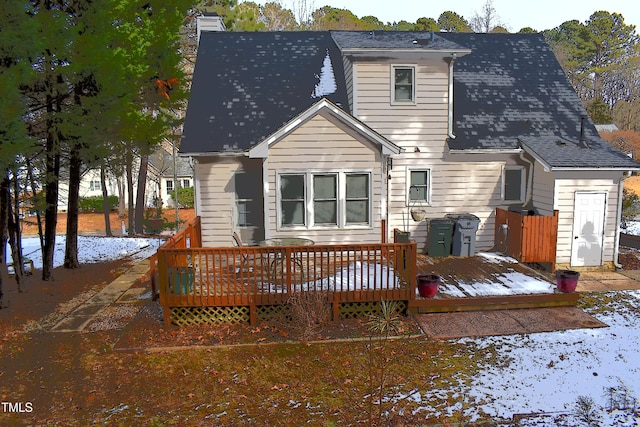 snow covered house with a deck