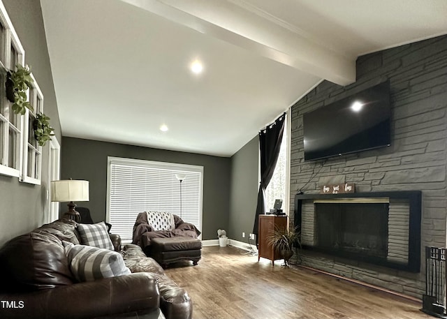 living room featuring hardwood / wood-style flooring, vaulted ceiling with beams, and a fireplace