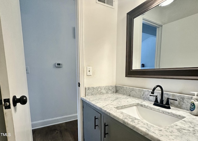 bathroom with vanity and wood-type flooring