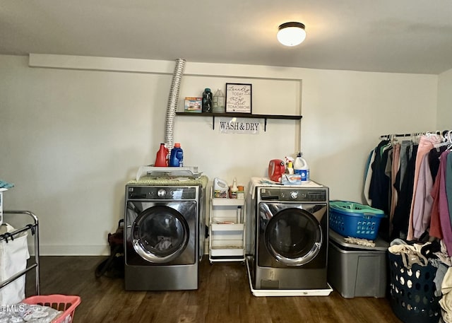 laundry area with dark hardwood / wood-style flooring and washer and clothes dryer