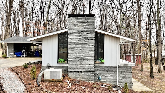 view of home's exterior featuring a carport and central air condition unit