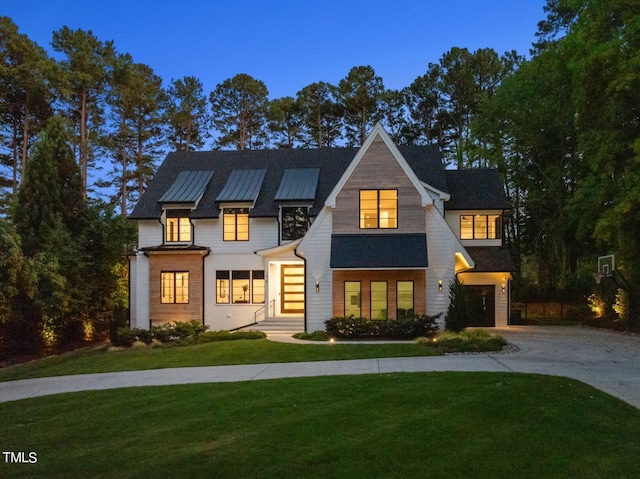 modern farmhouse featuring a lawn