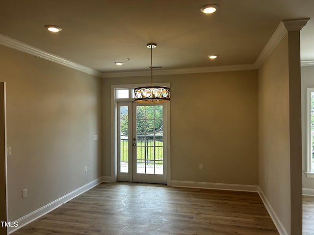 spare room with wood finished floors, baseboards, recessed lighting, and ornamental molding