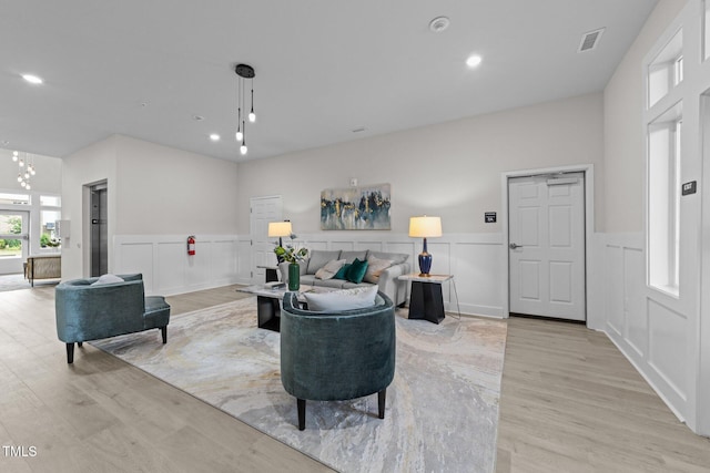 1400 Gathering Park Cir Unit 202, Cary, NC 27519 - living area featuring a wainscoted wall, light wood finished floors, a decorative wall, recessed lighting, and a chandelier