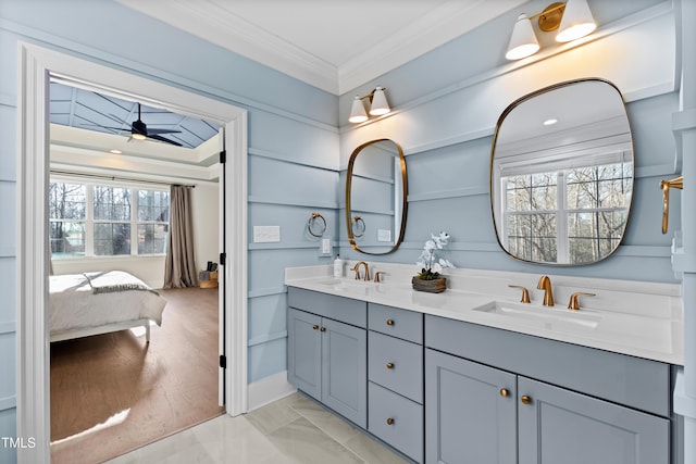 full bathroom with double vanity, crown molding, ceiling fan, and a sink