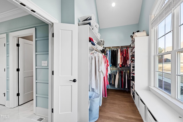 walk in closet featuring light wood finished floors