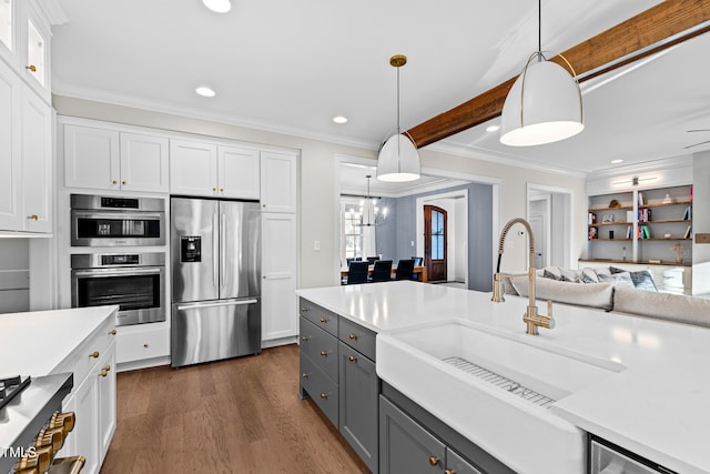 kitchen with gray cabinetry, a sink, white cabinets, light countertops, and appliances with stainless steel finishes