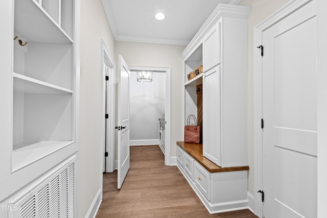 mudroom featuring baseboards, visible vents, wood finished floors, crown molding, and recessed lighting