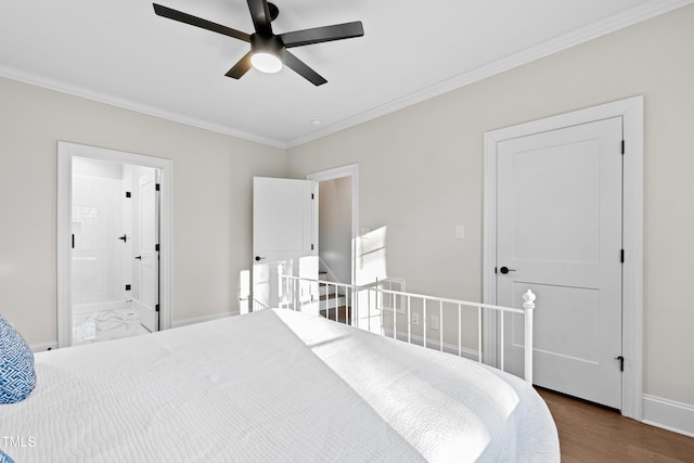 bedroom featuring ensuite bathroom, wood finished floors, visible vents, baseboards, and ornamental molding