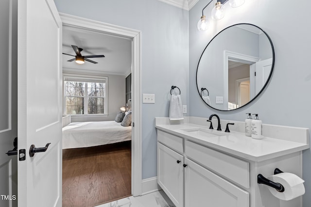 bathroom with baseboards, a ceiling fan, marble finish floor, crown molding, and vanity