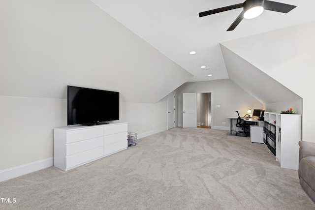 additional living space with light carpet, lofted ceiling, and baseboards