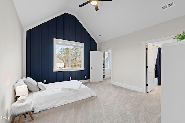 bedroom with baseboards, visible vents, a ceiling fan, light colored carpet, and vaulted ceiling