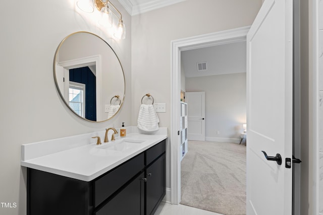 bathroom featuring ornamental molding, vanity, visible vents, and baseboards