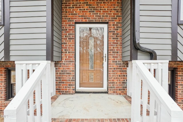 entrance to property with brick siding