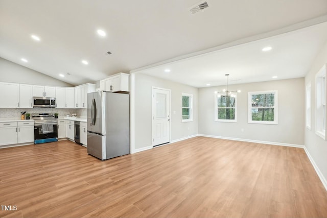 kitchen with visible vents, light countertops, decorative backsplash, appliances with stainless steel finishes, and white cabinetry