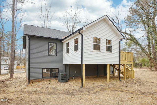 back of property featuring a deck, central AC, roof with shingles, a carport, and stairs