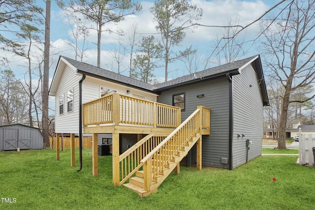 rear view of house featuring an outbuilding, a deck, stairway, a yard, and a storage shed