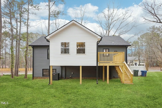 rear view of house with central air condition unit, stairs, roof with shingles, a lawn, and a deck