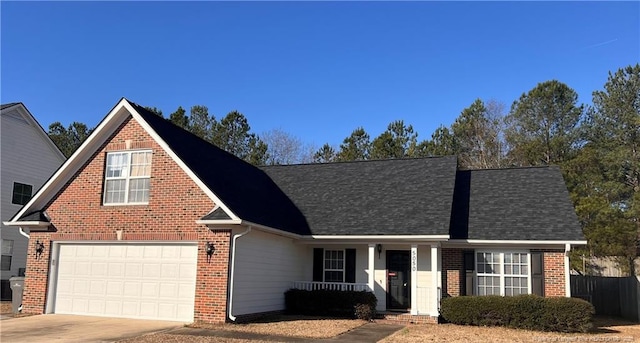 traditional-style house with driveway, a shingled roof, a garage, and brick siding