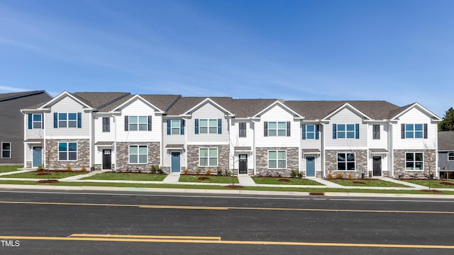 multi unit property with stone siding and a residential view