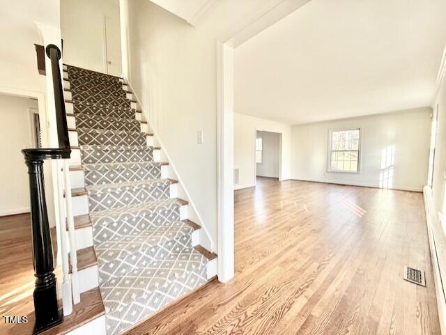 stairs featuring hardwood / wood-style floors