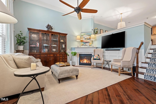 living room featuring ornamental molding, hardwood / wood-style floors, and ceiling fan