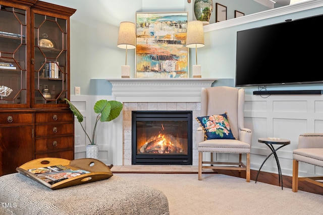 living area with a tiled fireplace