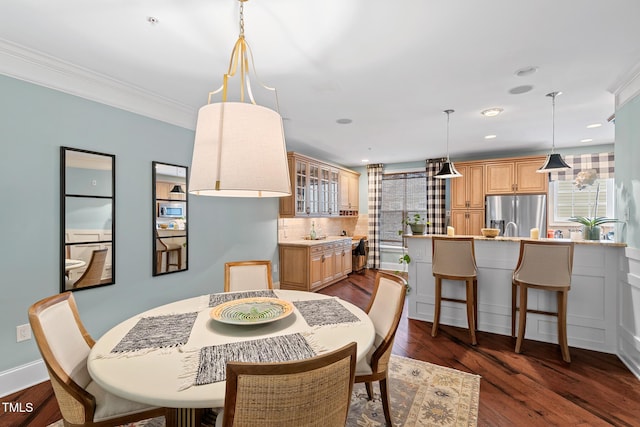 dining area with dark wood-type flooring and ornamental molding