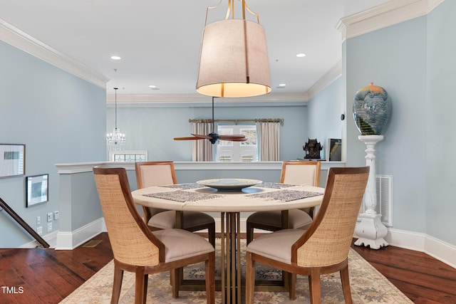 dining area featuring ornamental molding, dark hardwood / wood-style floors, and a notable chandelier