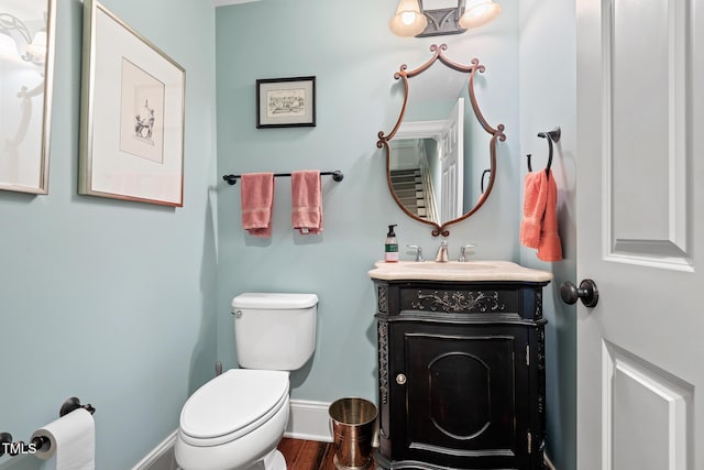 bathroom featuring hardwood / wood-style flooring, vanity, and toilet