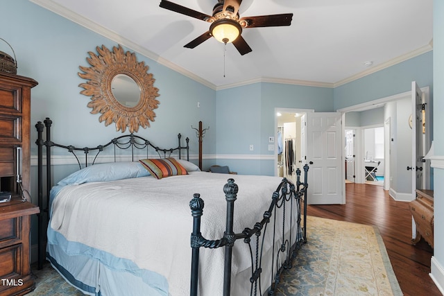 bedroom with crown molding, dark hardwood / wood-style floors, and ceiling fan