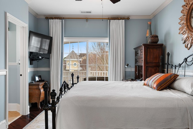 bedroom featuring crown molding, dark wood-type flooring, and ceiling fan