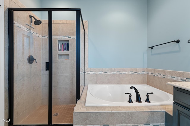 bathroom with vanity and independent shower and bath