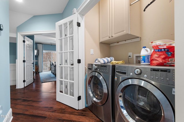 clothes washing area with cabinets, independent washer and dryer, and dark wood-type flooring