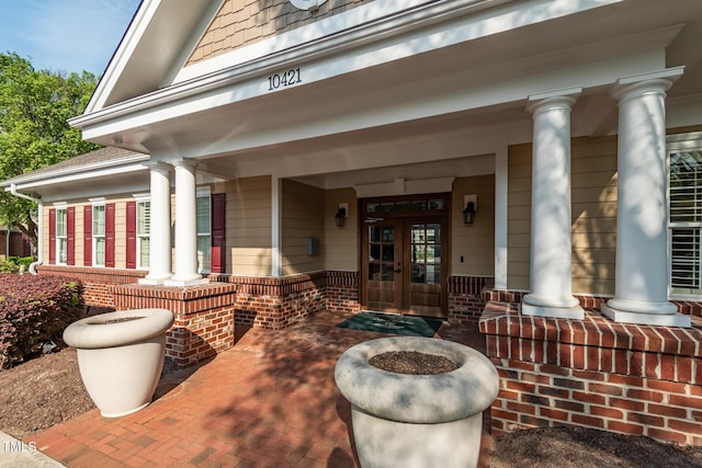 view of exterior entry with french doors and covered porch