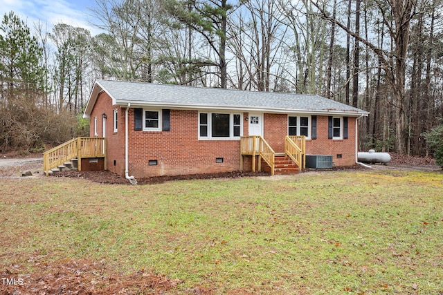 view of front of house with central AC unit and a front yard