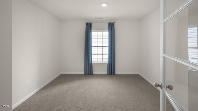 414 Ivory Ln, Goldsboro, NC 27534 - empty room with french doors and carpet floors
