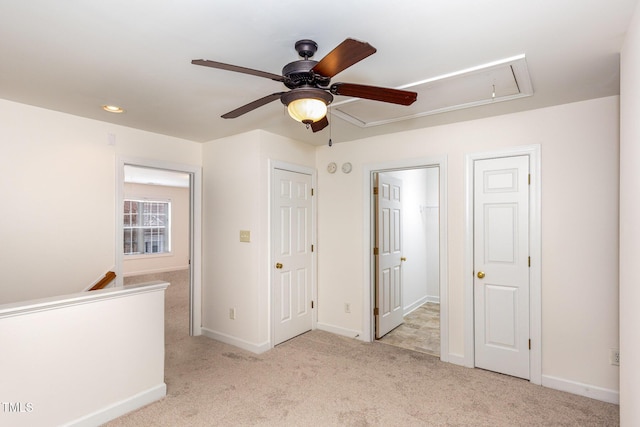 unfurnished bedroom with light carpet and ceiling fan