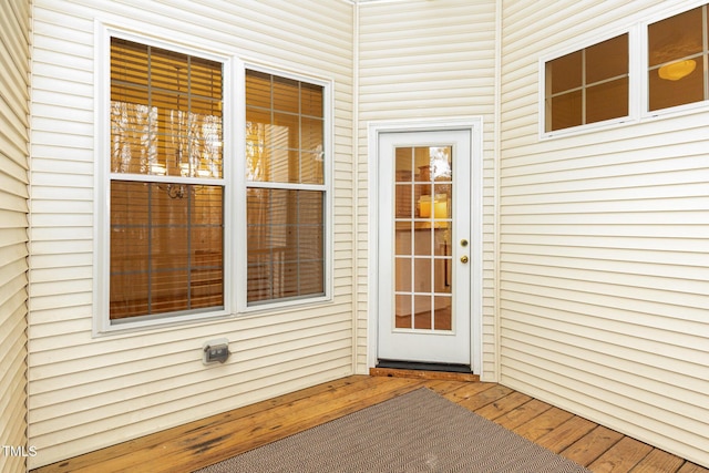 view of exterior entry featuring a wooden deck