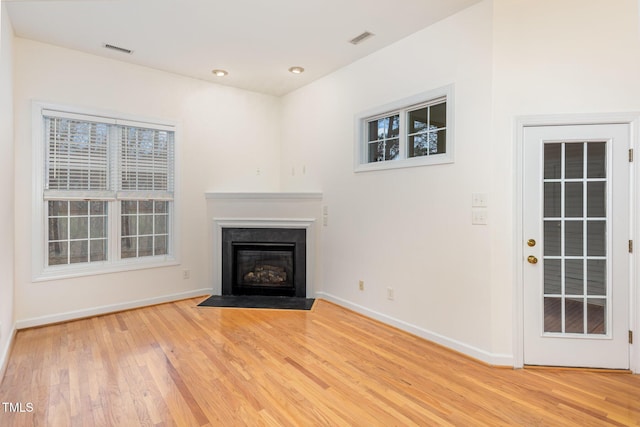 unfurnished living room with hardwood / wood-style flooring