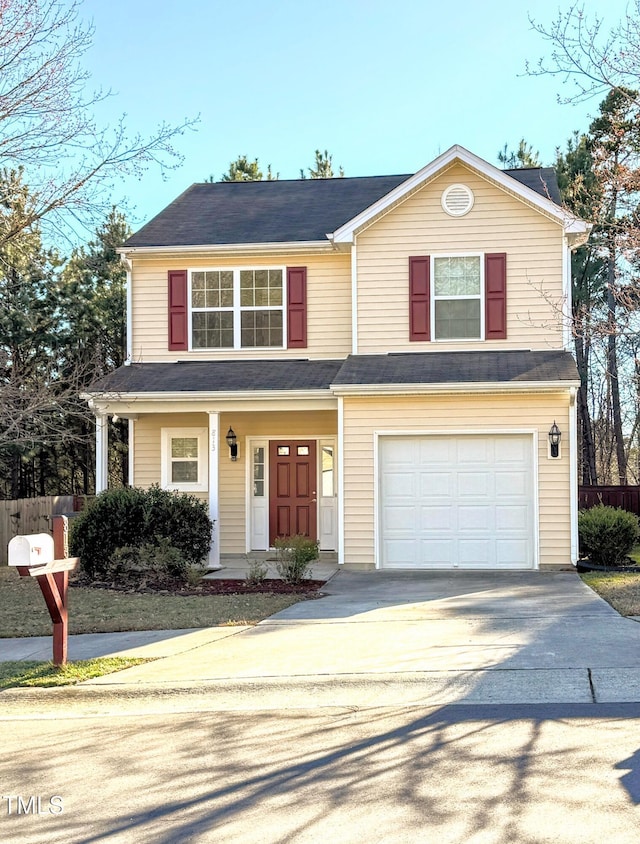 traditional home with a garage and concrete driveway