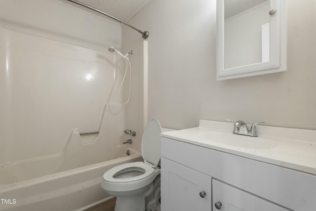 full bathroom featuring toilet, bathing tub / shower combination, vanity, and a textured ceiling